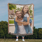 Couple holding a custom woven photo blanket outdoors
