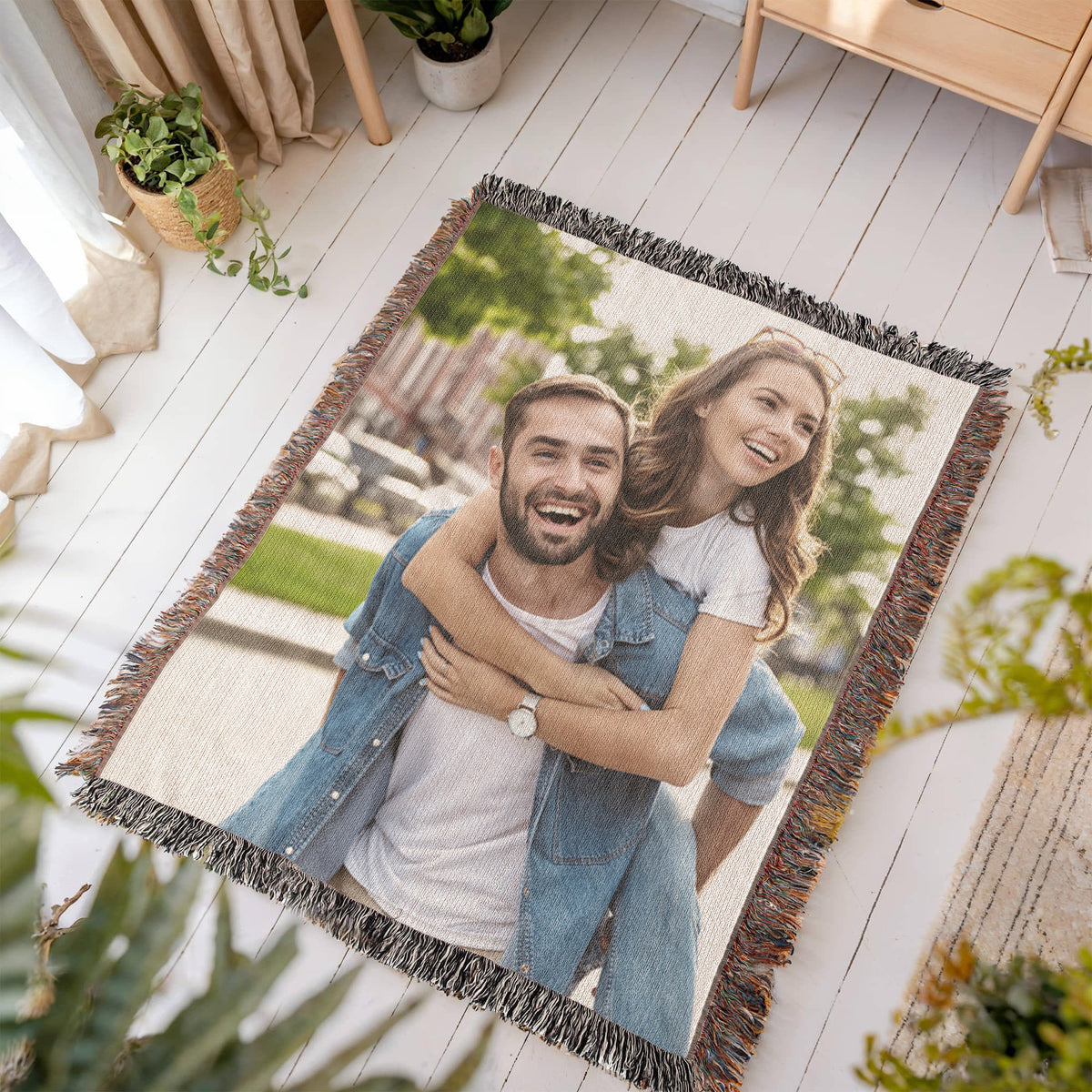 Custom photo blanket laid out on a light wood floor